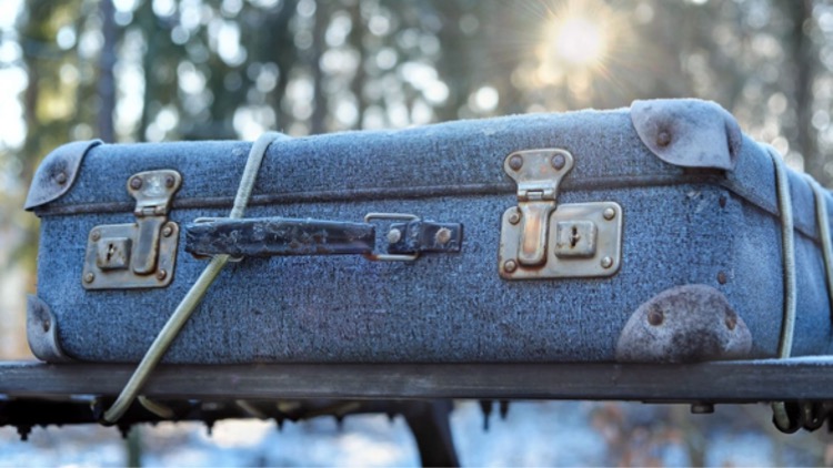 photo of suitcase in snow